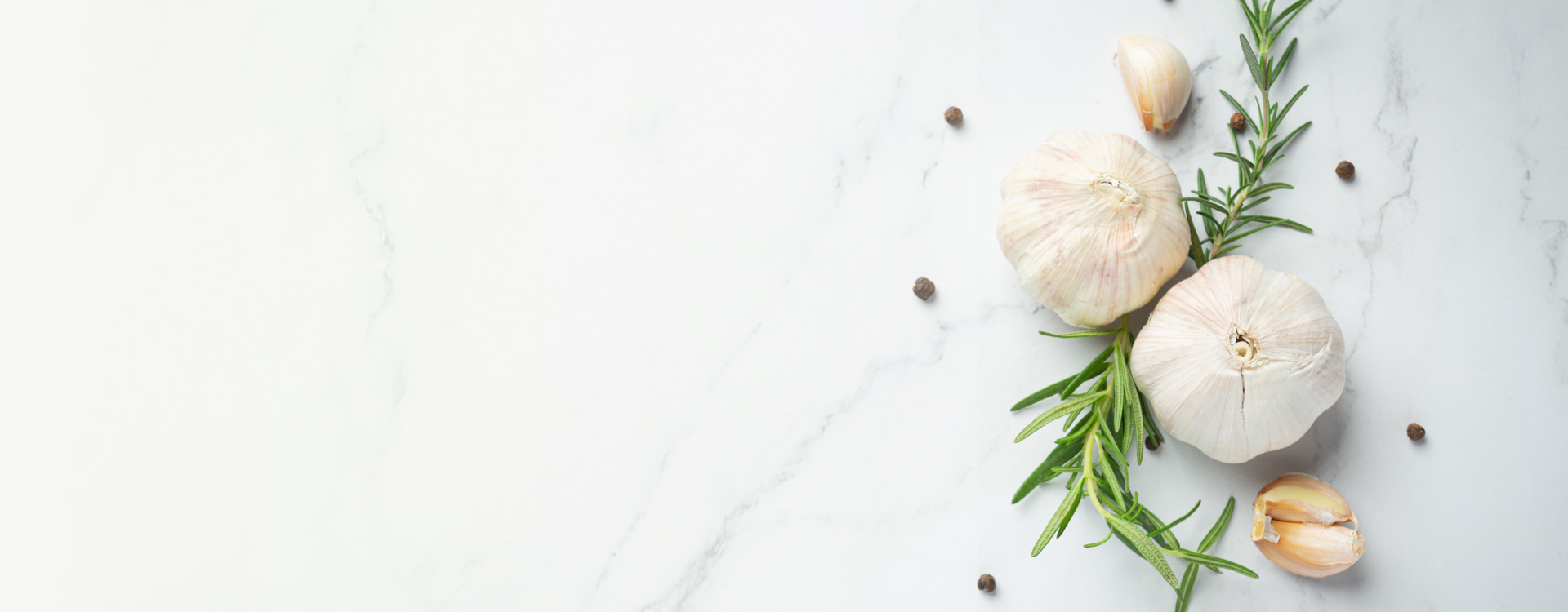 Sa Baronia Menu Detail of garlic and rosemary on a white background
