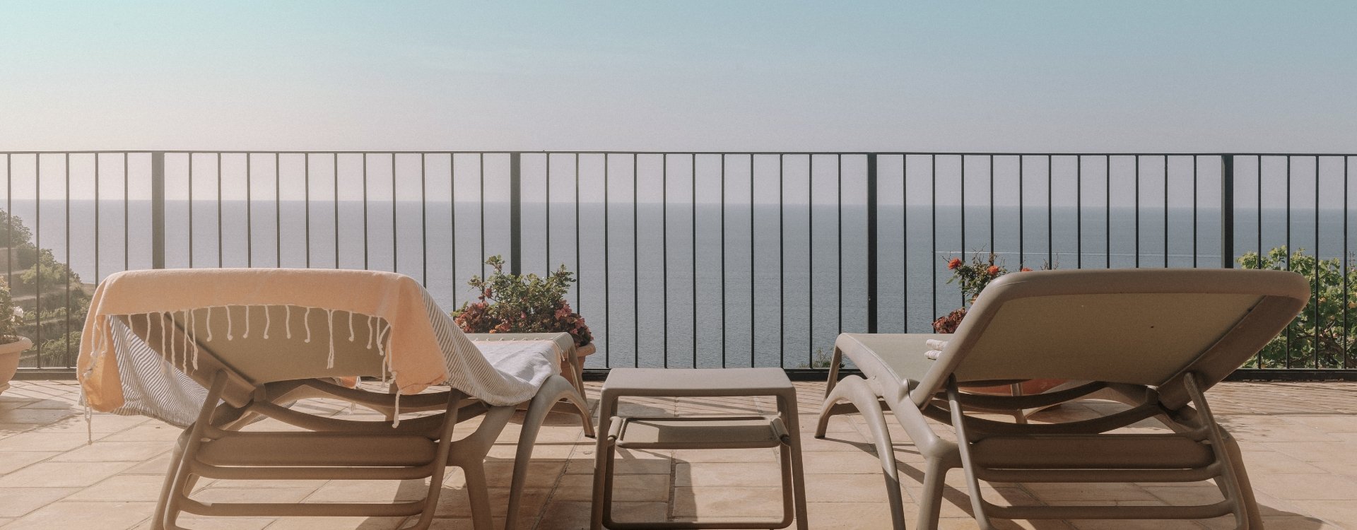 Balcony overlooking the sea View from one of the front rooms of Hostal Sa Baronia