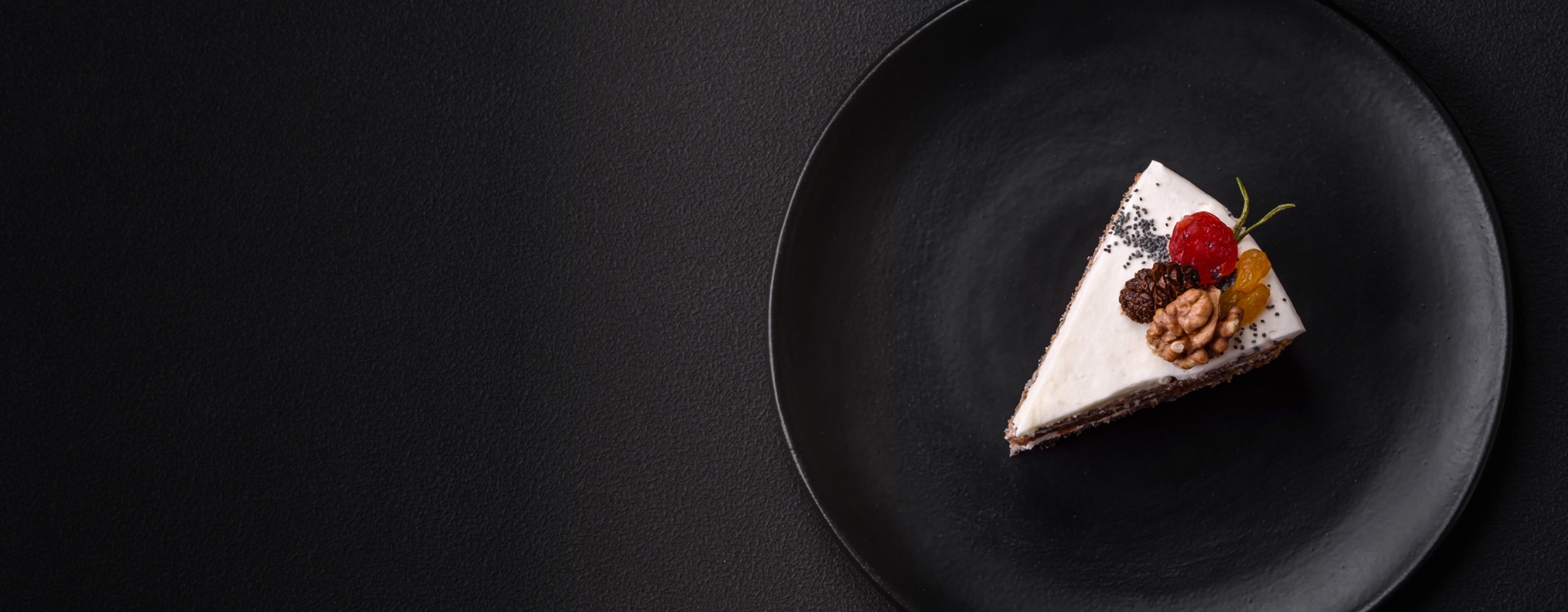 Dessert Portion of cake on black plate